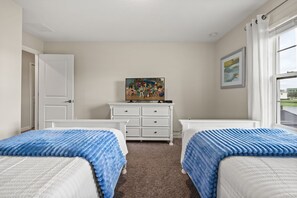 A bedroom with two beds, a dresser, and a television on the dresser. - 4 BD/ 3 BA/ Storey Lake (4887 RC) (Kissimmee)