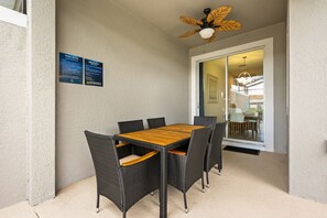 A dining area with a table and chairs, a ceiling fan, and a glass door leading to another room. - 4 BD/ 3 BA/ Storey Lake (4887 RC) (Kissimmee)