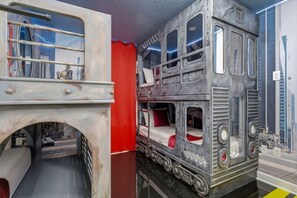 A room with a double-decker bed and a mural of a bridge. - Immersive Experience 9 BD/ 5  BA/ Champions Gate (1513 MC) (Davenport)