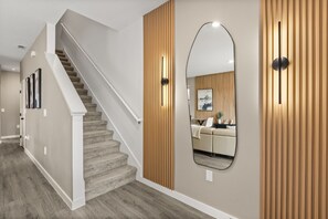 A staircase leading to a living area with a sofa and a coffee table. - 3 BD/ 3 BA/ The Hub at Westside Reserve (3227 SW) (Kissimmee)