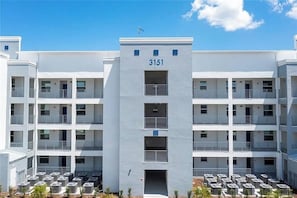 A multi-story building with a central entrance and numbered unit 3151. - 2 BD/ 2 BA/ Storey Lake (3151-302 PC) (Kissimmee)