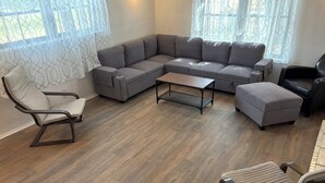 A modern living room with a sectional sofa, a small coffee table, and two armchairs. - 3-Acre Wildlife Retreat : Sleeps & Dines 12 : 5 mi to Duncan: 26 mi to Fort Sill (Marlow)