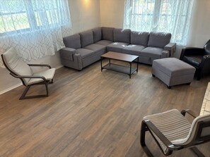 A modern living room with a sectional sofa, a small coffee table, and two armchairs. - 3-Acre Wildlife Retreat : Sleeps & Dines 12 : 5 mi to Duncan: 26 mi to Fort Sill (Marlow)