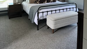 A bedroom with a bed, a nightstand, a lamp, a ceiling fan, and a window with blinds. - Spacious 4-bedroom house in perfect Murfreesboro with AC (Murfreesboro)