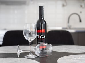 A bottle of wine and two wine glasses on a table. - Duplex One Bedroom Apartment (Punat)