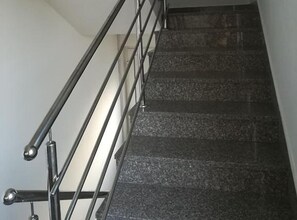 A staircase with metal railings and dark granite steps. - One Bedroom Apartmant with Sea View and Balcony (Šibenik)