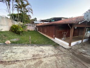 A residential property with a paved driveway, a wooden garage, and a satellite dish.