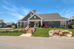 A two-story building with a gabled roof and a front porch.