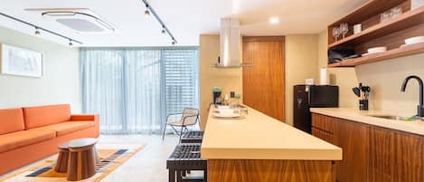 A modern kitchen with a central island, wooden cabinets, and a built-in oven.