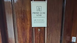 A wooden door with a sign indicating 'PRIME LUXE STAY' by Lavish Hub Properties.