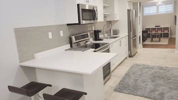 Coffee/tea maker, fridge, microwave, oven