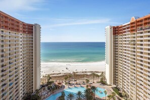 A high-rise hotel with a view of a beach and a swimming pool. - 2-Bedroom Beachfront Condo at Shores of Panama! (Panama City Beach)
