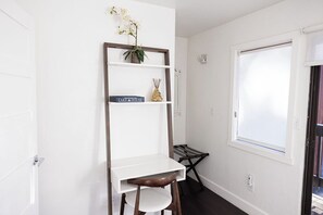A white room with a desk, chair, and a window. - Charming 2-bedroom/2-bath getaway in South Lake Tahoe. (South Lake Tahoe)