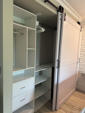 A walk-in closet with open shelving, drawers, and a sliding door. - On the Golf Course! The BEST of Biltmore walk to shops AMC Theater, restaurants! (Phoenix Biltmore)