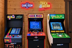 Three arcade machines with neon signs, including Ms. Pac-Man, NBA Jam, and Golden Tee 3D Golf. - Luxury Smoky Retreat | Pool, Theater & Hot Tub (Sevierville)