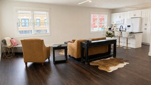 A modern living room with a sofa, coffee table, and a rug.