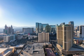A cityscape with various buildings, including a prominent hotel with a distinctive architectural design.