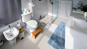 A modern bathroom with a toilet, bidet, sink, and shower area. - ★Luxury Beachfront Oasis ~ Ocean Views ~ ♛King Bed (San Juan)