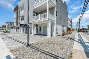 A multi-story residential building with a sign indicating 'NEW CONSTRUCTION.' - Luxury Jersey Shore Retreat Rooftop Oasis & Beach (Seaside Heights)
