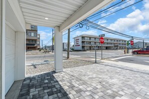 A gas station with a stop sign, a one-way sign, and a building with a sign for a motel and restaurant. - Luxury Jersey Shore Retreat Rooftop Oasis & Beach (Seaside Heights)