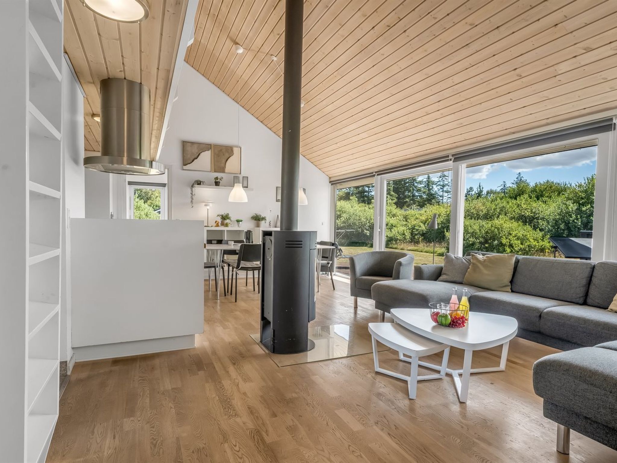 A modern interior with a kitchen, dining area, and living space.