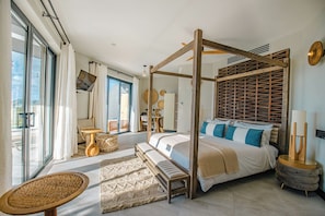 A spacious bedroom with a four-poster bed, a large window, and a view of the outdoors. - Seastar: Luxury 2-Bedroom Ocean-View Suite with Private Pool, Antigua (Urlings)
