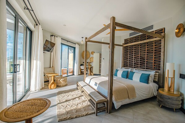 Un dormitorio amplio con cama con dosel, un ventanal y vistas al exterior.
