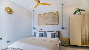 A modern bedroom with a bed, a ceiling fan, a wall-mounted woven panel, and a wardrobe. - Seastar: Luxury 2-Bedroom Ocean-View Suite with Private Pool, Antigua (Urlings)