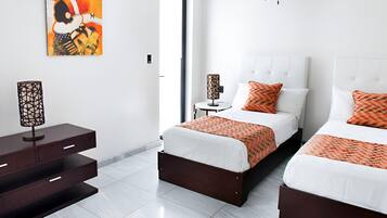 A modern hotel room with two beds, a nightstand, a lamp, and a painting on the wall.