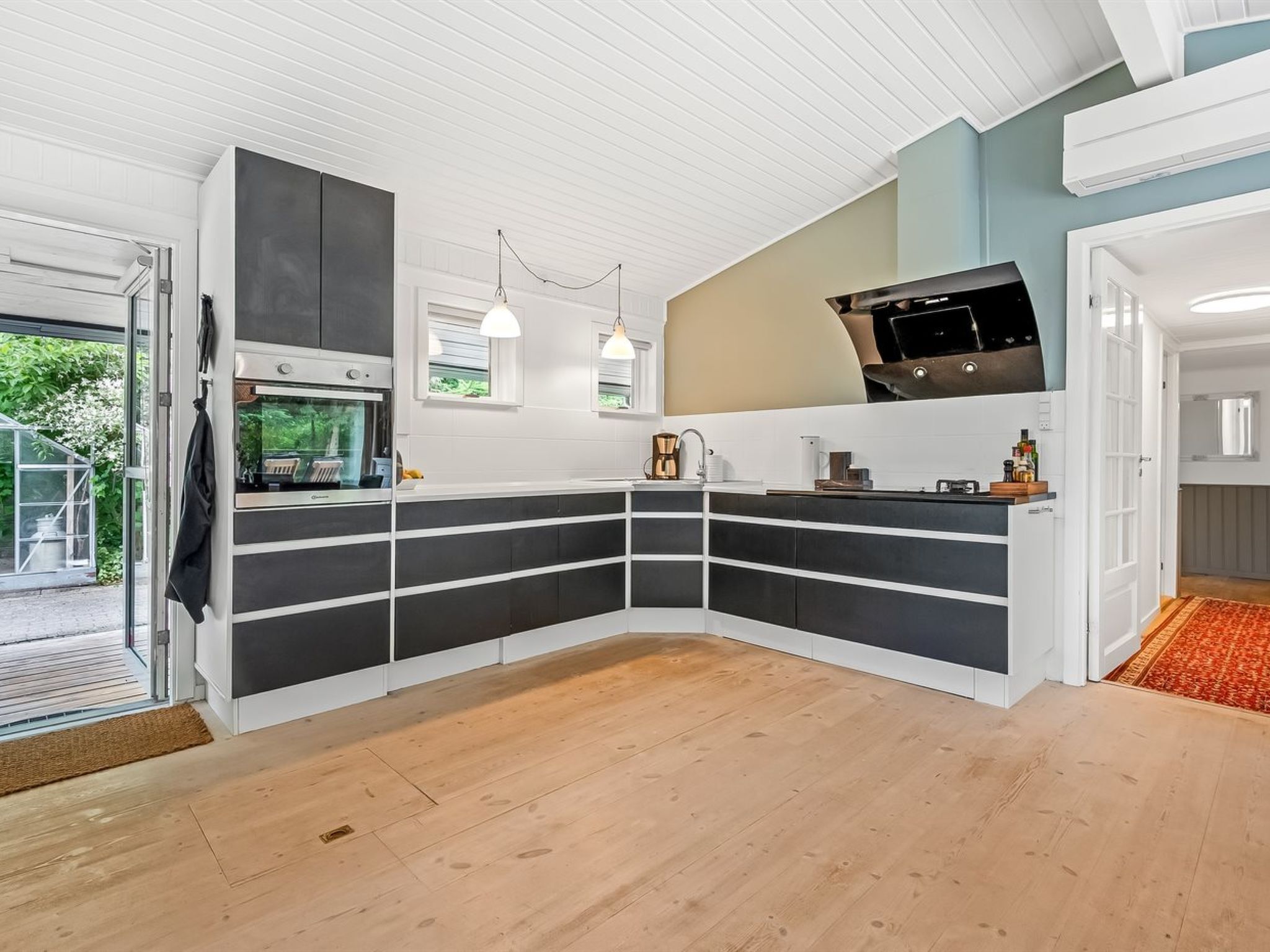 A modern kitchen with built-in storage, a microwave, and a coffee maker.