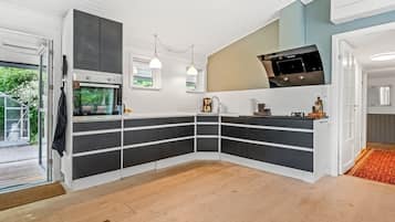 A modern kitchen with built-in storage, a microwave, and a coffee maker.