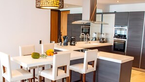 A modern kitchen with white countertops, stainless steel appliances, and a central island with seating. - Beach House 5: Luxury 3-Bedroom Beach House with Private Pool, Antigua (Urlings)