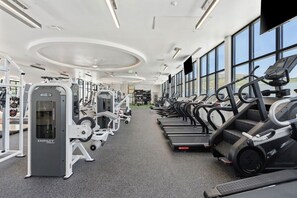 A gym with treadmills, weight machines, and a large window. - Top Floor! Pool | Spa| Bowling| Parking| King Bed! (Salt Lake City)