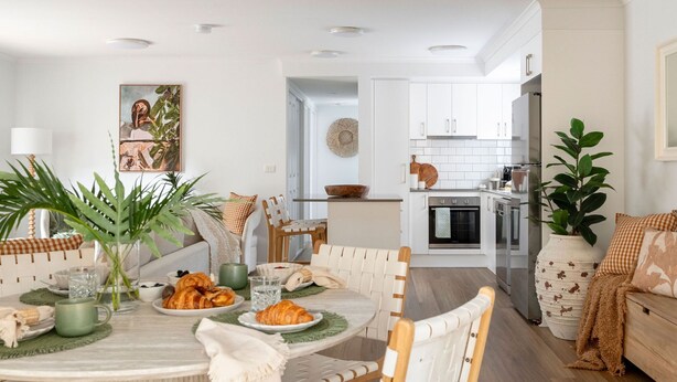 A modern kitchen with white cabinets, a built-in oven, and a refrigerator. - Acacia Mollymook Beach | Pool & Tennis Court (Mollymook Beach)