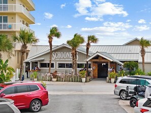 A beachfront hotel with a sign reading 'SCHOONE'S LAST LOCAL BEACH CLUB'. - 3BR Charming PCB House, Fire Pit, Fenced Yard (Panama City)