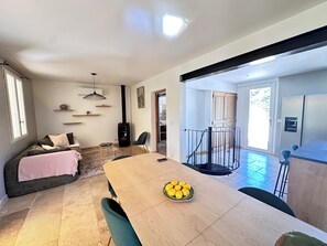 A modern living space with a dining area, a sofa, a fireplace, and a view of the outside. - Beautiful Provençal estate surrounded by 1 hectare of nature in the Luberon (Saint-Saturnin-lès-Apt)