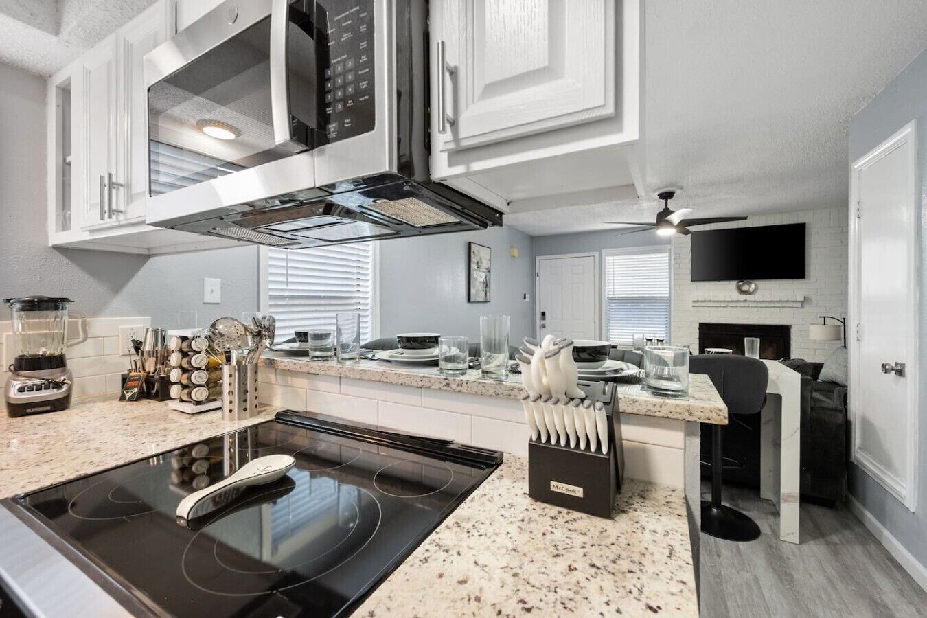 A modern kitchen with a built-in stove, microwave, and oven.