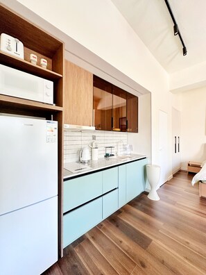 A modern kitchen with a built-in microwave, a coffee maker, and a sink. - Haven III- Quiet Luxury next to Shangri-La UB (Ulaanbaatar)