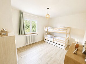A child's bunk bed room with a window, radiator, and a wooden cabinet. - Les Glaieuls by Interhome (Deauville-Trouville)