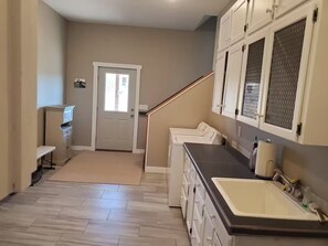 A laundry area with a washing machine, a dryer, and a sink with a faucet. - CO Mountain getaway (Kremmling)