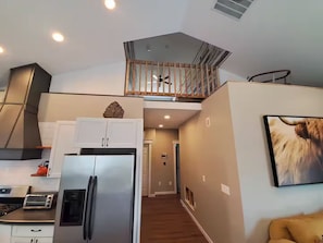 A modern kitchen with a stainless steel refrigerator, a built-in oven, and a toaster. - CO Mountain getaway (Kremmling)