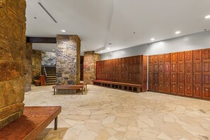 A stone-floored lobby with wooden lockers, a bench, and a staircase. - Hyatt Main St Studio | Steps to Peak 9 + Downtown (Breckenridge)