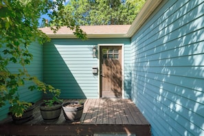 A wooden deck with potted plants, a door, and a window. - Spacious Golden Home Near Red Rocks & DT with EV (Golden)