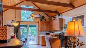 A cozy kitchen with wooden cabinets, a dining area with a table and chairs, and a large window overlooking greenery. - Room With A View by Avantstay King Studio + Loft + Full Kitchen Oak Hills + 30 Min to Coast (Paso Robles)
