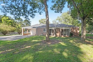 A two-story brick house with a covered porch, a garage, and a lawn. - Peaceful 2bed /1 bath corporate duplex Powder Springs - Cobb county pet friendly (Powder Springs)
