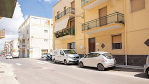 A street with parked cars and buildings. - The Ancient Sailing Ship - Alghero (Alghero)