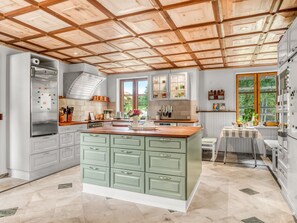 A kitchen with a central island, wooden ceiling, and a view of the outdoors. - "Ajna" - 20.9km from the sea by Interhome (Jerslev J)
