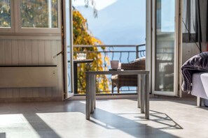 Una habitación moderna con balcón, una mesa y una silla.