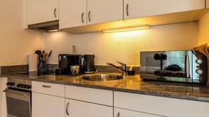 A kitchenette with a coffee maker, toaster, and sink. - Wake to the Matterhorn in Luxury 1084 (Wallis)