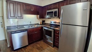 A compact kitchen with a dishwasher, microwave, stove, oven, and refrigerator. - South Pointe Villas 6 - Oceanfront Complex (Oceanview Unit) in Garden City Beach (Garden City)